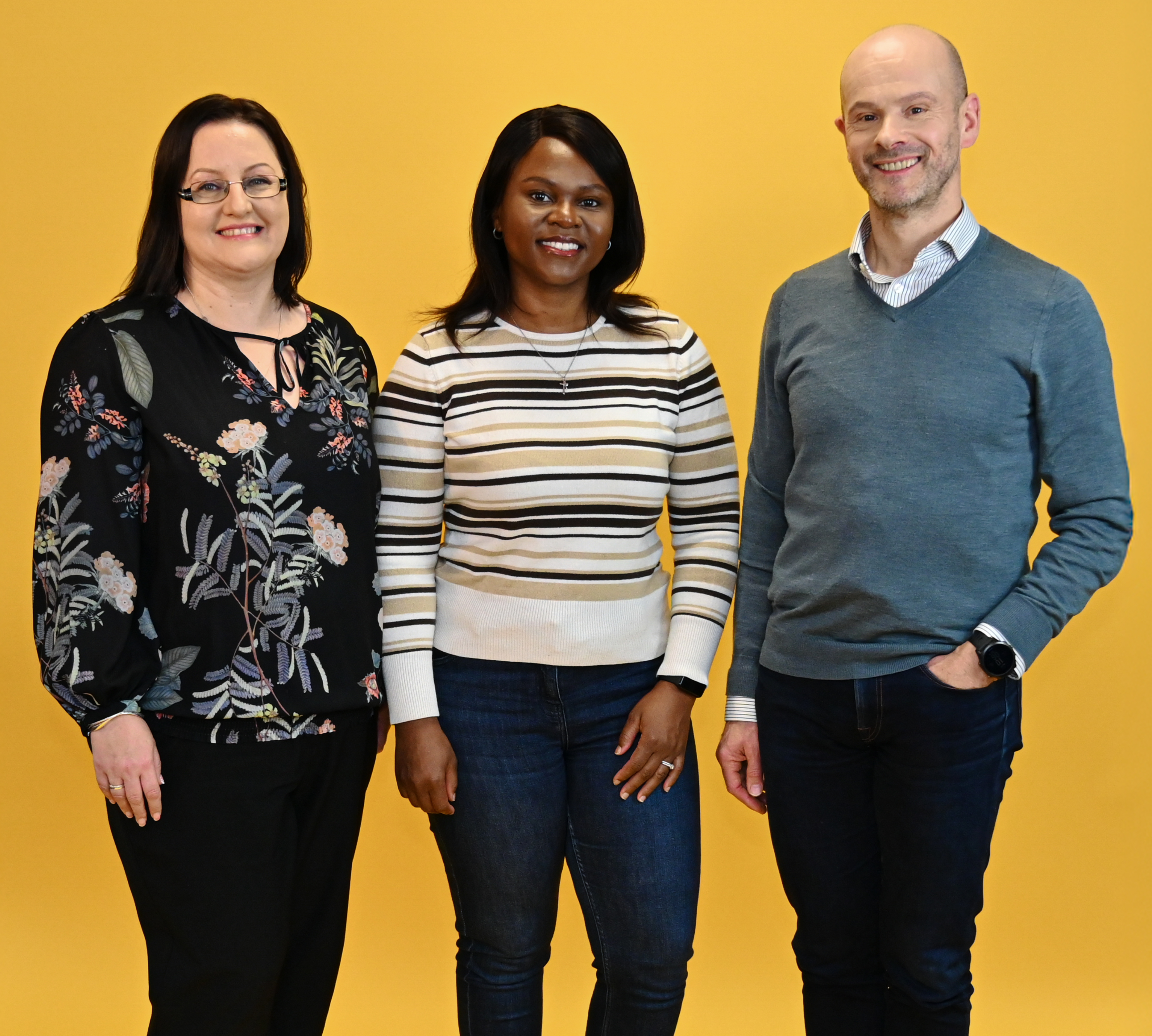 three employees laughing